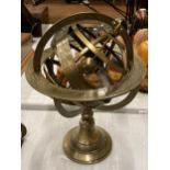 A BRASS REVOLVING GLOBE STYLE DESK COMPASS WITH BIRTH SIGNS