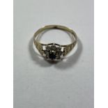 A 9 CARAT GOLD RING WITH CENTRE SAPPHIRE SURROUNDED BY CUBIC ZIRCONIAS SIZE P