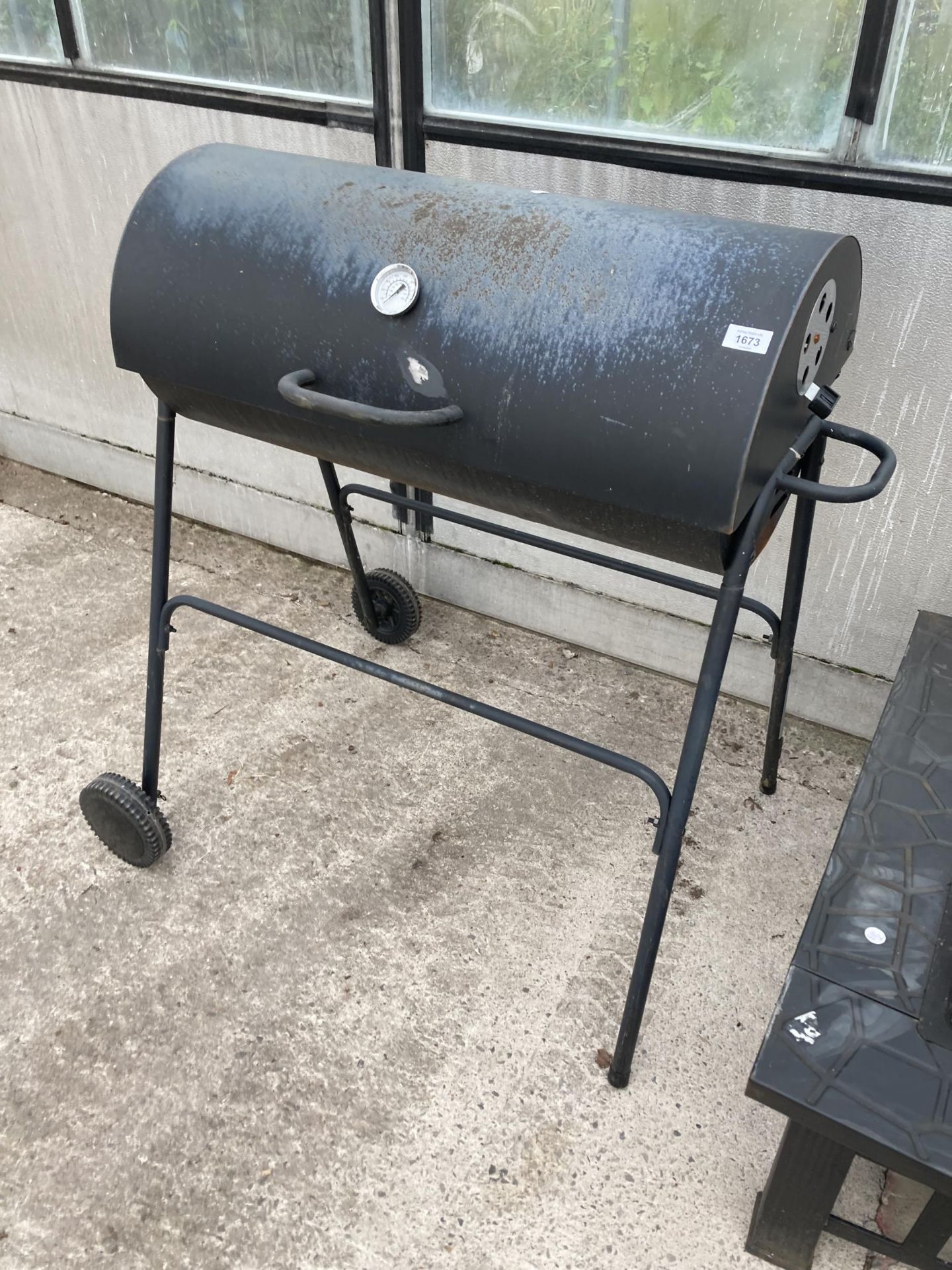 A SMALL METAL CHARCOAL BBQ