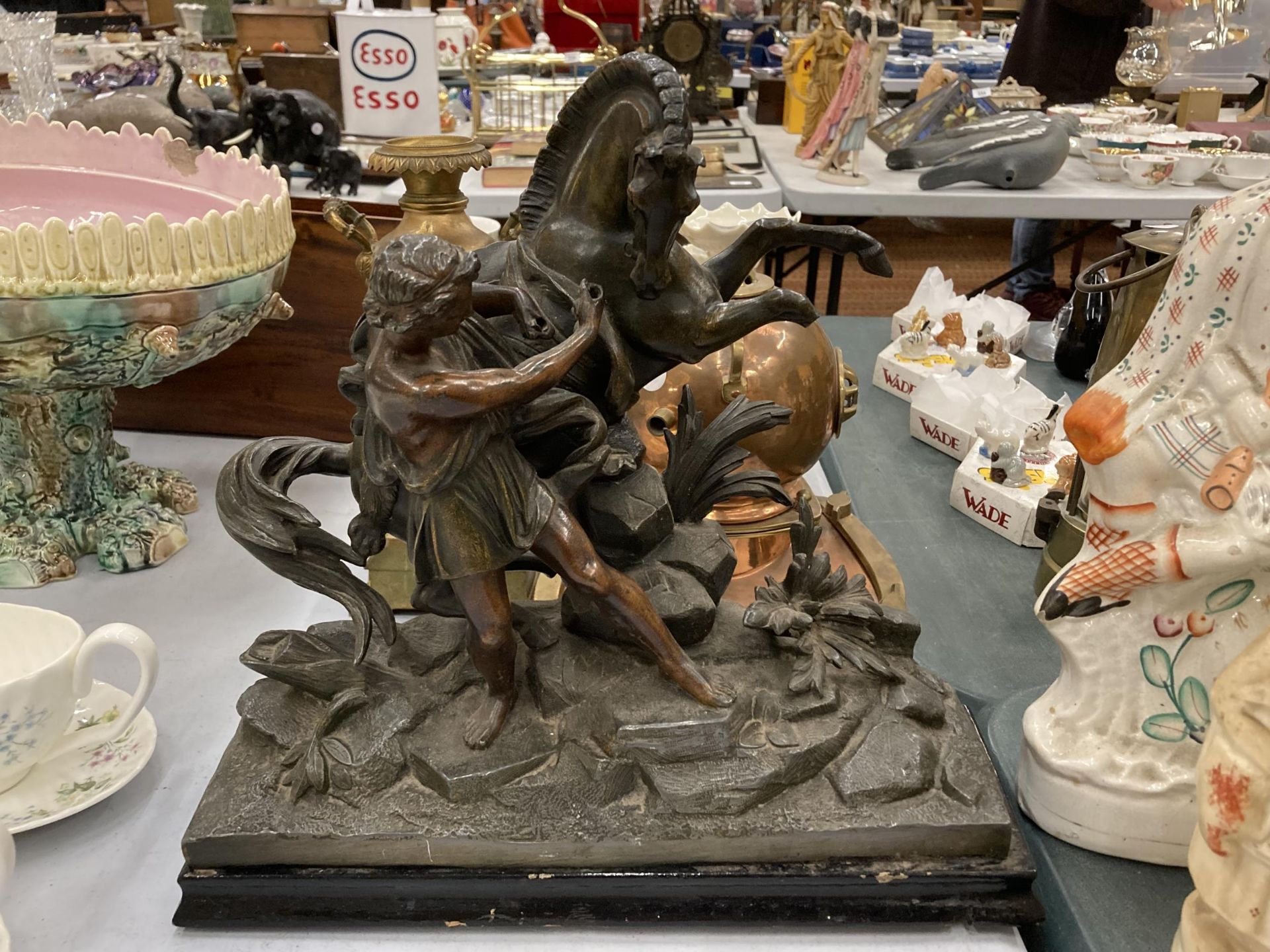 A VERY HEAVY FRENCH SPELTER FIGURE OF A MAN AND HORSE ON A WOODEN BASE, HEIGHT 33CM, LENGTH 35CM -