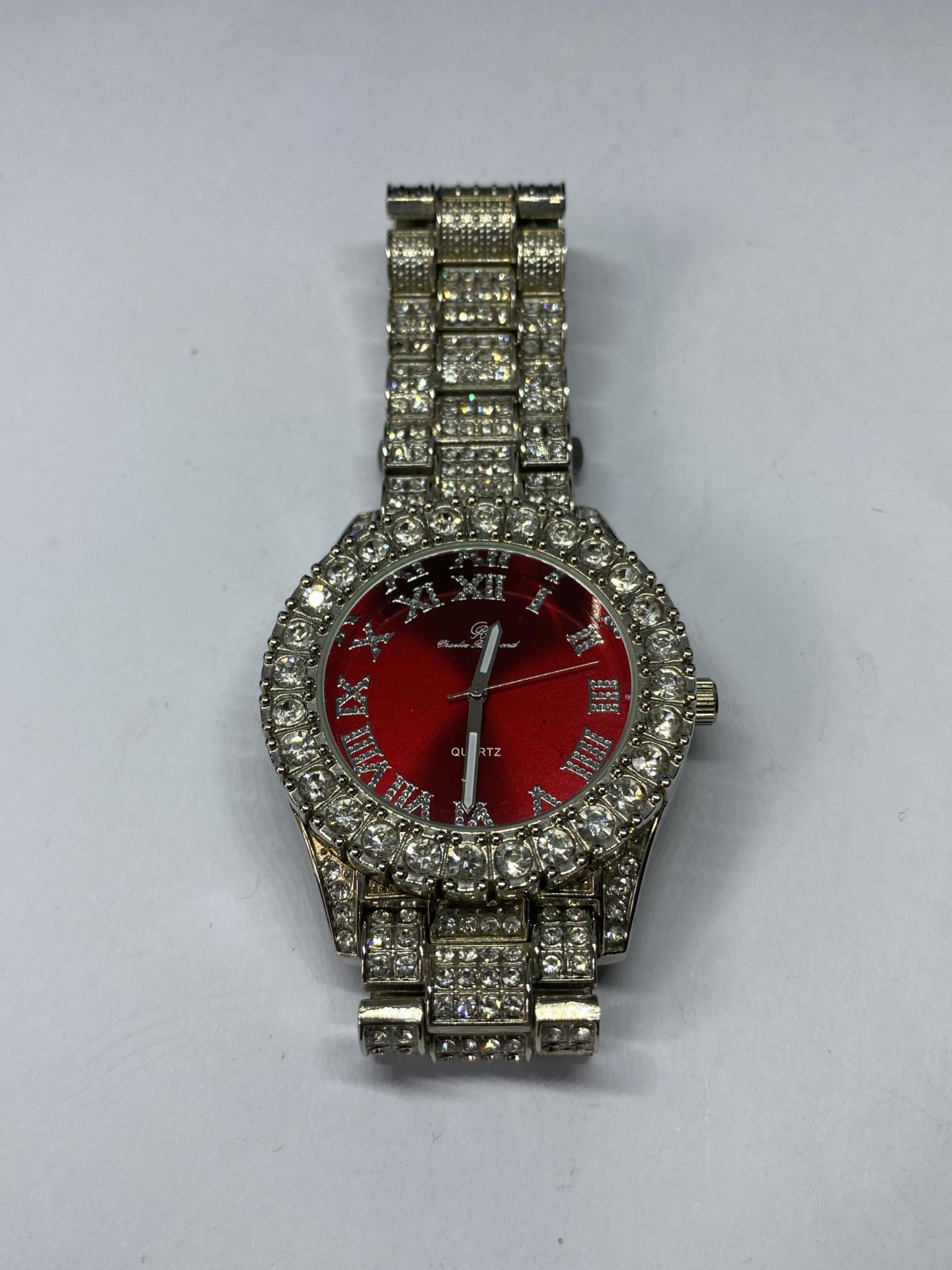 A DECORATIVE DIAMANTE WRIST WATCH SEEN WORKING BUT NO WARRANTY