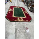 A LARGE OCTAGONAL GREEN, RED AND GOLD 200 OUNCE PURE WOOL RUG, - 423 CM X 271 CM (COST £5000 FROM