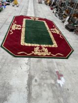 A LARGE OCTAGONAL GREEN, RED AND GOLD 200 OUNCE PURE WOOL RUG, - 423 CM X 271 CM (COST £5000 FROM