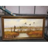 A LARGE GILT FRAMED OIL ON CANVAS PAINTING OF DUCKS FLYING OVER A RIVER, SIGNED GAILEY 132CM X 70CM