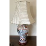 A CHINESE ENAMEL DESIGN TABLE LAMP WITH GEOMETRIC AND FLORAL DESIGNS, ON CARVED WOODEN BASE AND