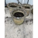 A SET OF THREE CIRCULAR RECONSTITUTED STONE PLANTERS