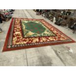 A LARGE GREEN, RED AND GOLD 200 OUNCE PURE WOOL RUG, - 485 CM X 358 CM (COST £8000 FROM SIGNATURE