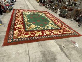 A LARGE GREEN, RED AND GOLD 200 OUNCE PURE WOOL RUG, - 485 CM X 358 CM (COST £8000 FROM SIGNATURE