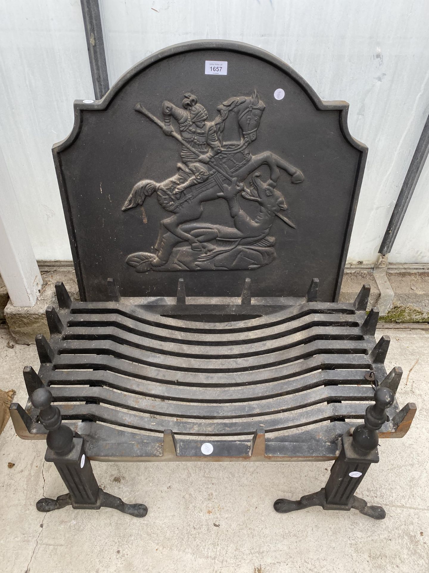 A LARGE DECORATIVE CAST IRON FIRE GRATE WITH FIRE DOGS AND A DECORATIVE FIRE BACK