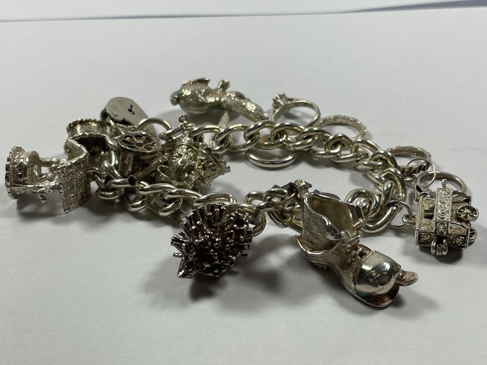 A SILVER CHARM BRACELET WITH ELEVEN CHARMS AND A HEART PADLOCK - Image 3 of 3