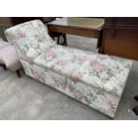 A DAY BED OTTOMAN WITH FLORAL UPHOLSTERY