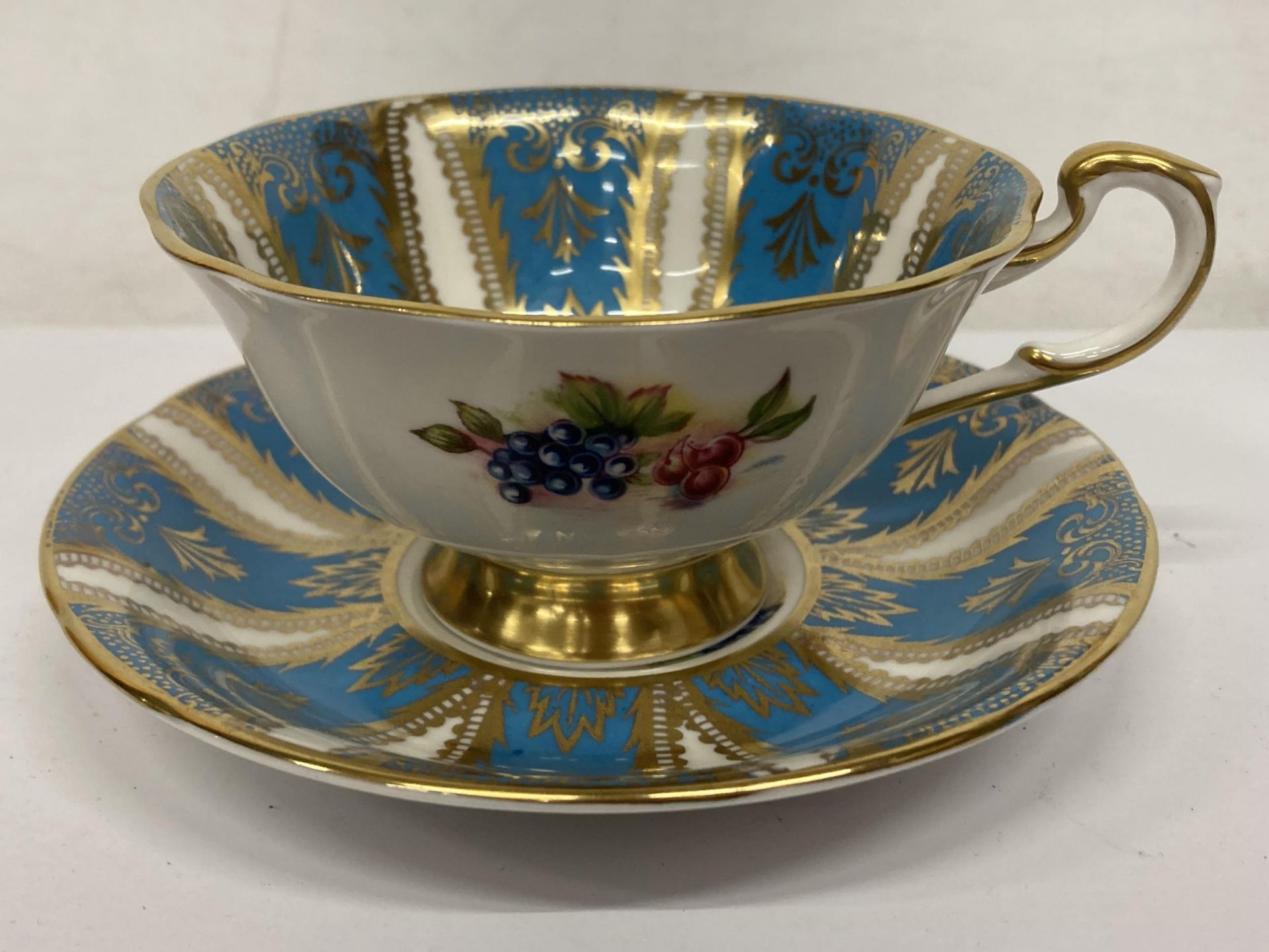 A VINTAGE PARAGON TEAL BLUE WITH FRUIT FOOTED TEACUP AND SAUCER - Image 2 of 4