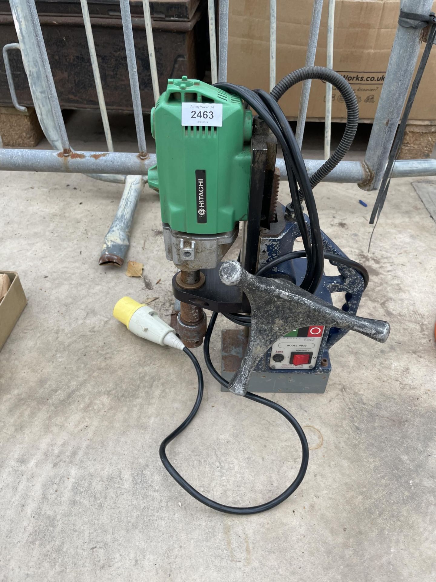 A 110V HITACHI DRILL AND A DRILL STAND