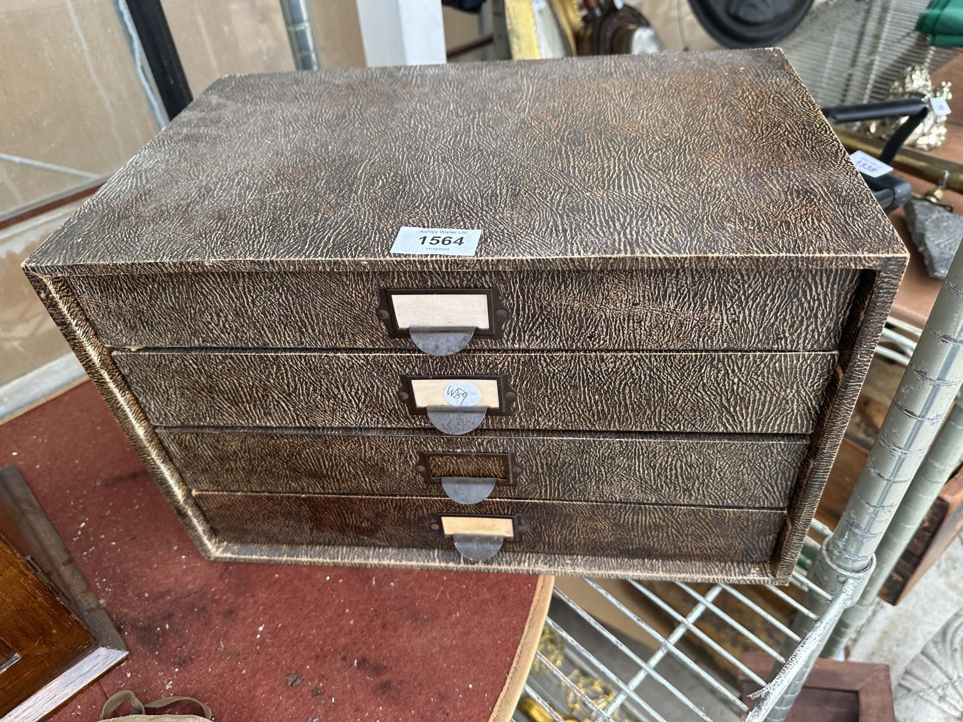 A FOUR DRAWER 'WINEL' STATIONARY FILING CABINET