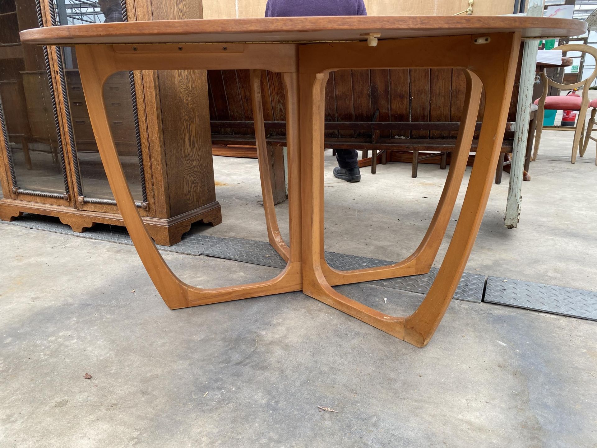 A RETRO TEAK 50" DIAMETER CROSS-FRAME GATELEG DINING TABLE - Image 2 of 5