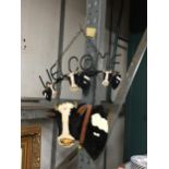 A METAL COW DESIGN HANGING WELCOME SIGN
