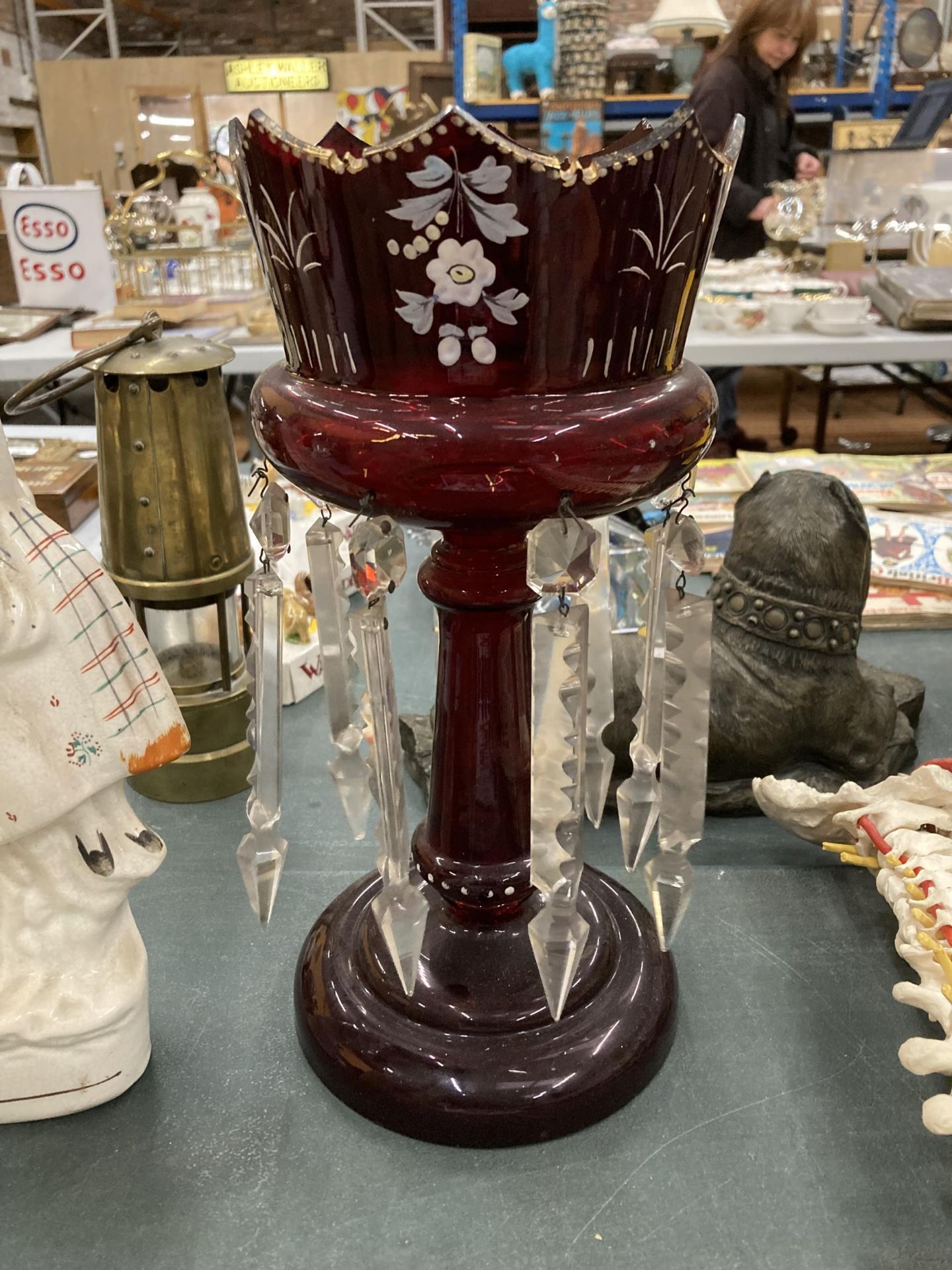 A LARGE CRANBERRY GLASS CANDLE HOLDER WITH HANDPAINTED DECORATION AND CRYSTAL DROPLETS, HEIGHT 31CM