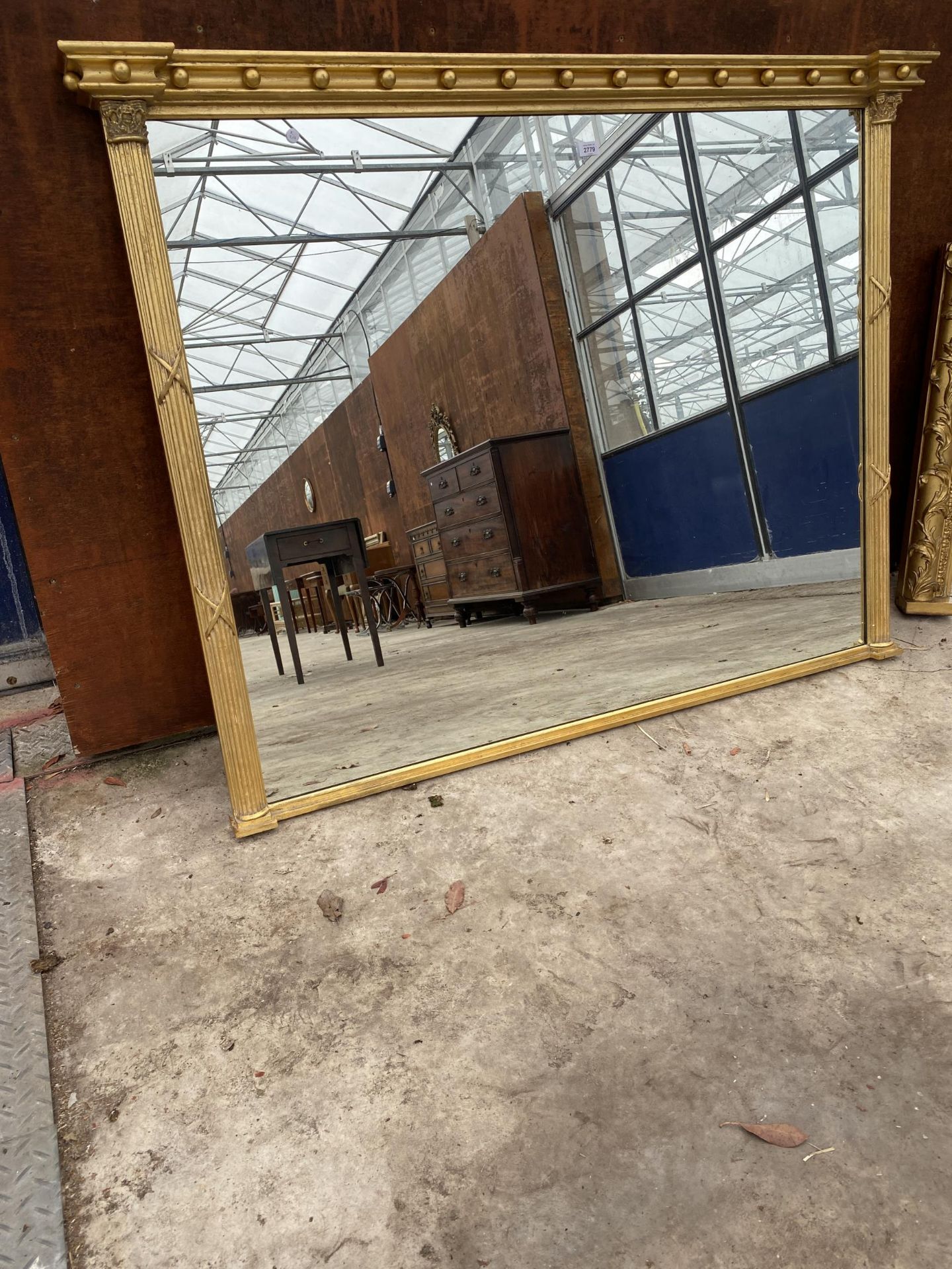 A 19TH CENTURY STYLE GILT FRAMED OVERMANTEL MIRROR WITH CORINTHIAN COLUMN SIDE SUPPORTS, 60 X 46"