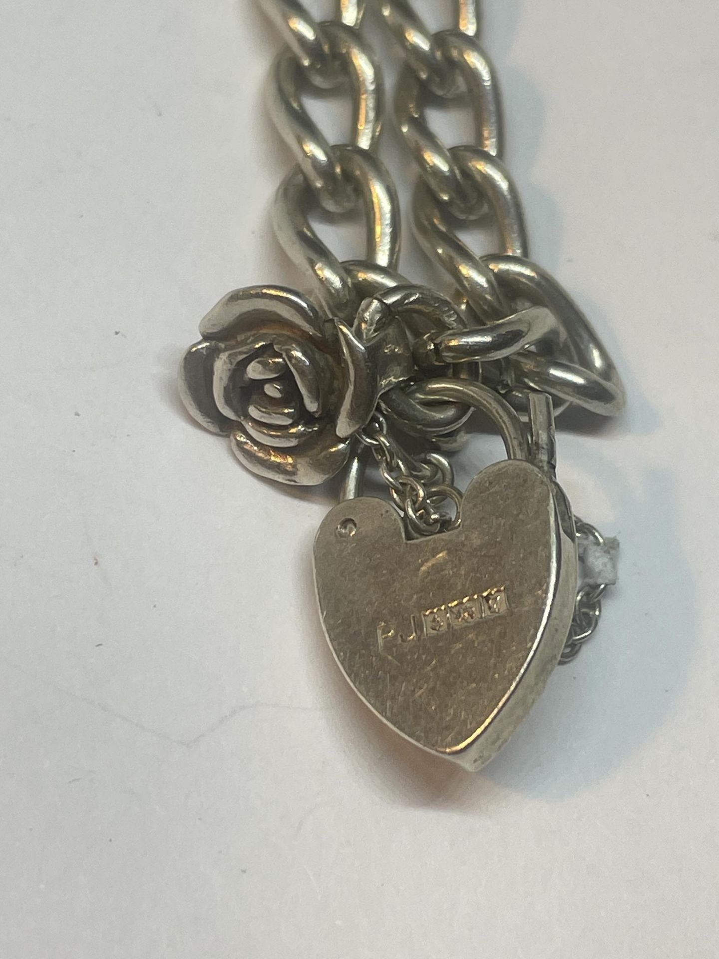 A SILVER WRIST CHAIN WITH ROSE CHARM WITH SILVER HEART PADLOCK - Image 2 of 3