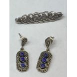 A SILVER BROOCH AND A PAIR OF EARRINGS
