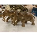 A PAIR OF CERAMIC ELEPHANTS WITH IMPRESSED MARK TO UNDERSIDE, HEIGHT 14CM, LENGTH 22CM