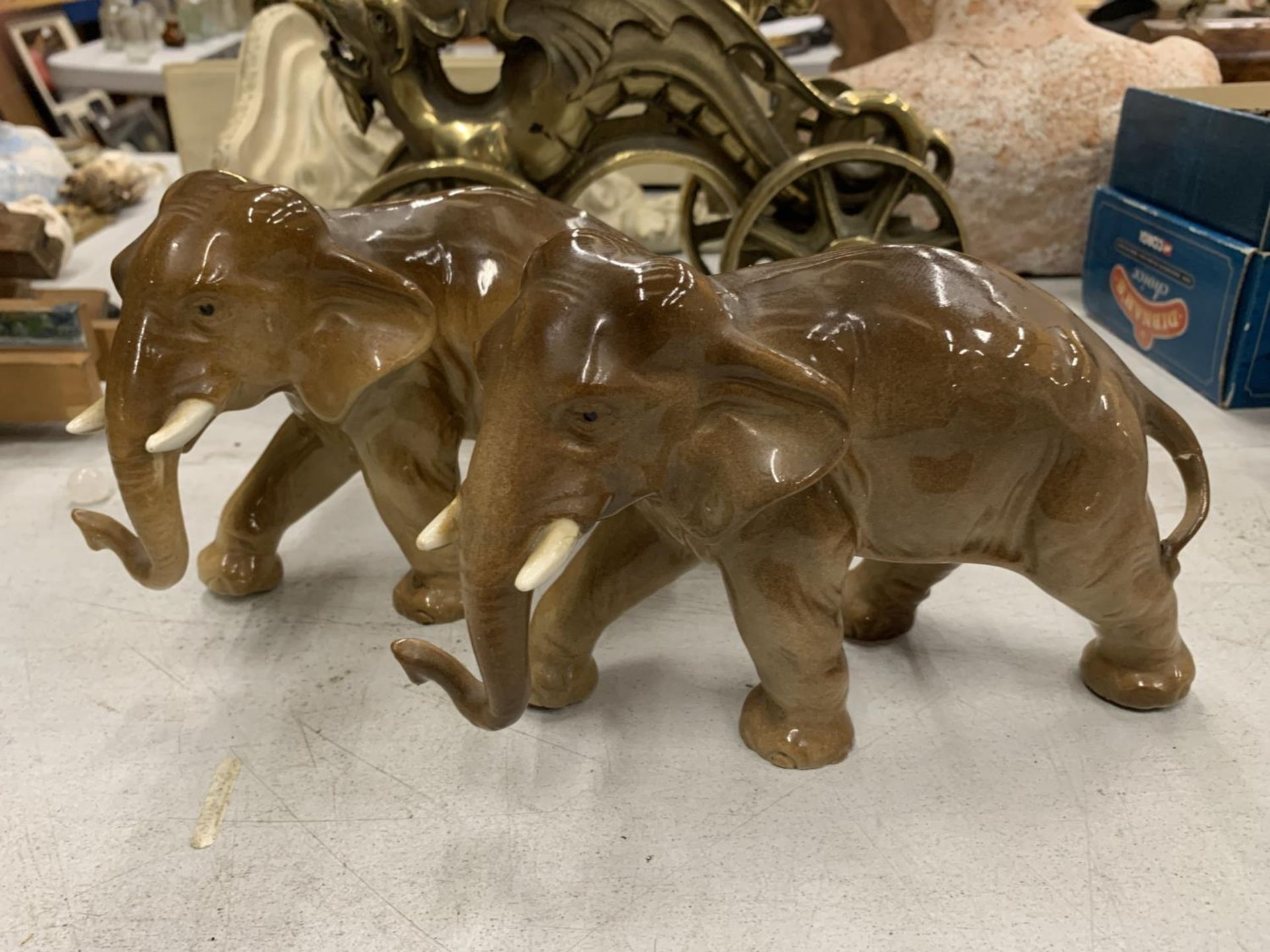 A PAIR OF CERAMIC ELEPHANTS WITH IMPRESSED MARK TO UNDERSIDE, HEIGHT 14CM, LENGTH 22CM