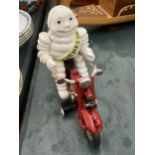 A CAST MODEL OF A MICHELIN MAN ON A MOTOR BIKE, HEIGHT 16CM