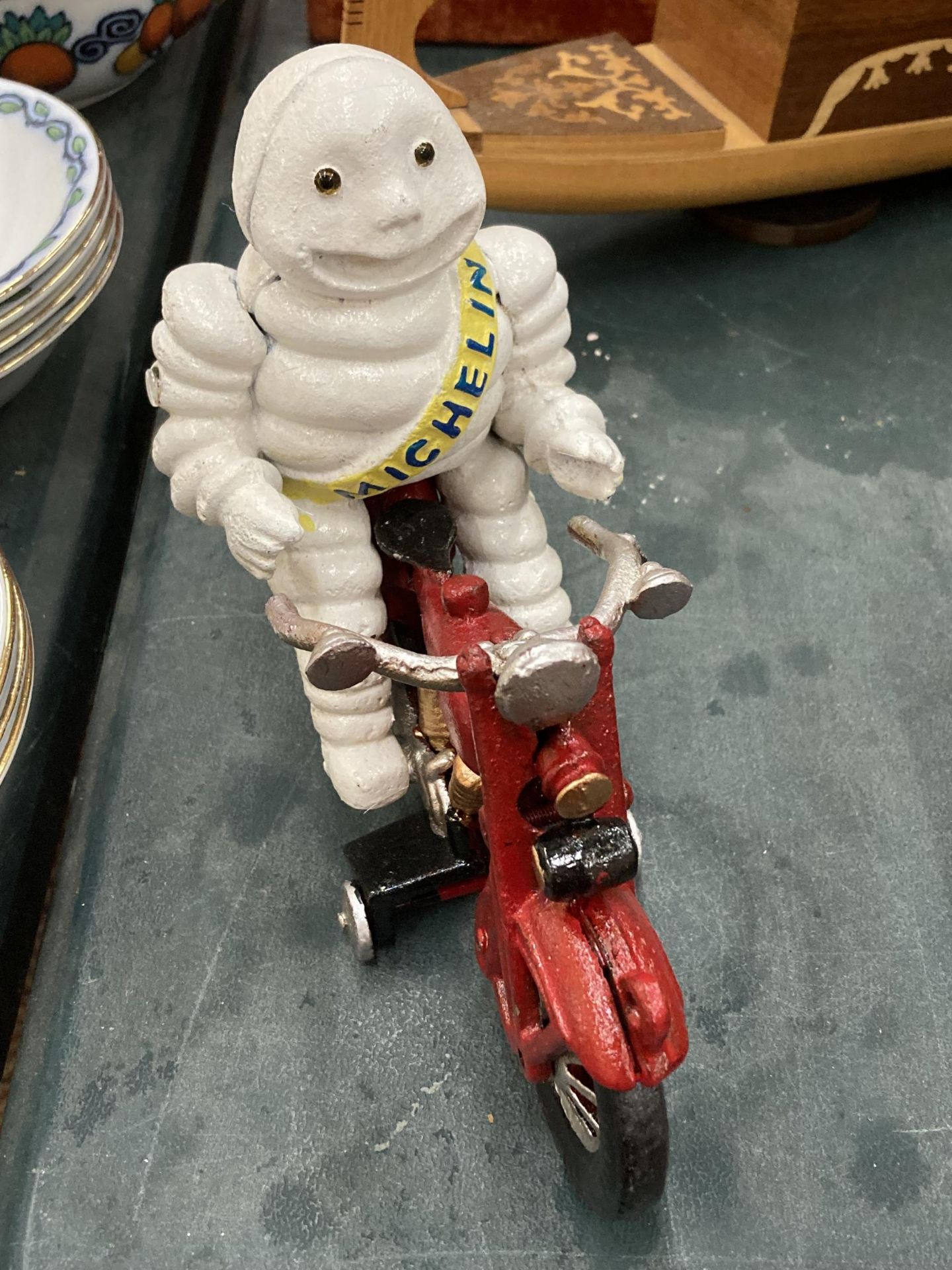 A CAST MODEL OF A MICHELIN MAN ON A MOTOR BIKE, HEIGHT 16CM