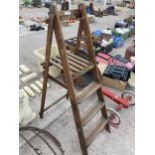 A VINTAGE THREE RUNG WOODEN STEP LADDER