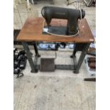 AN INDUSTRIAL SINGER SEWING MACHINE WITH BENCH AND TREADLE BASE