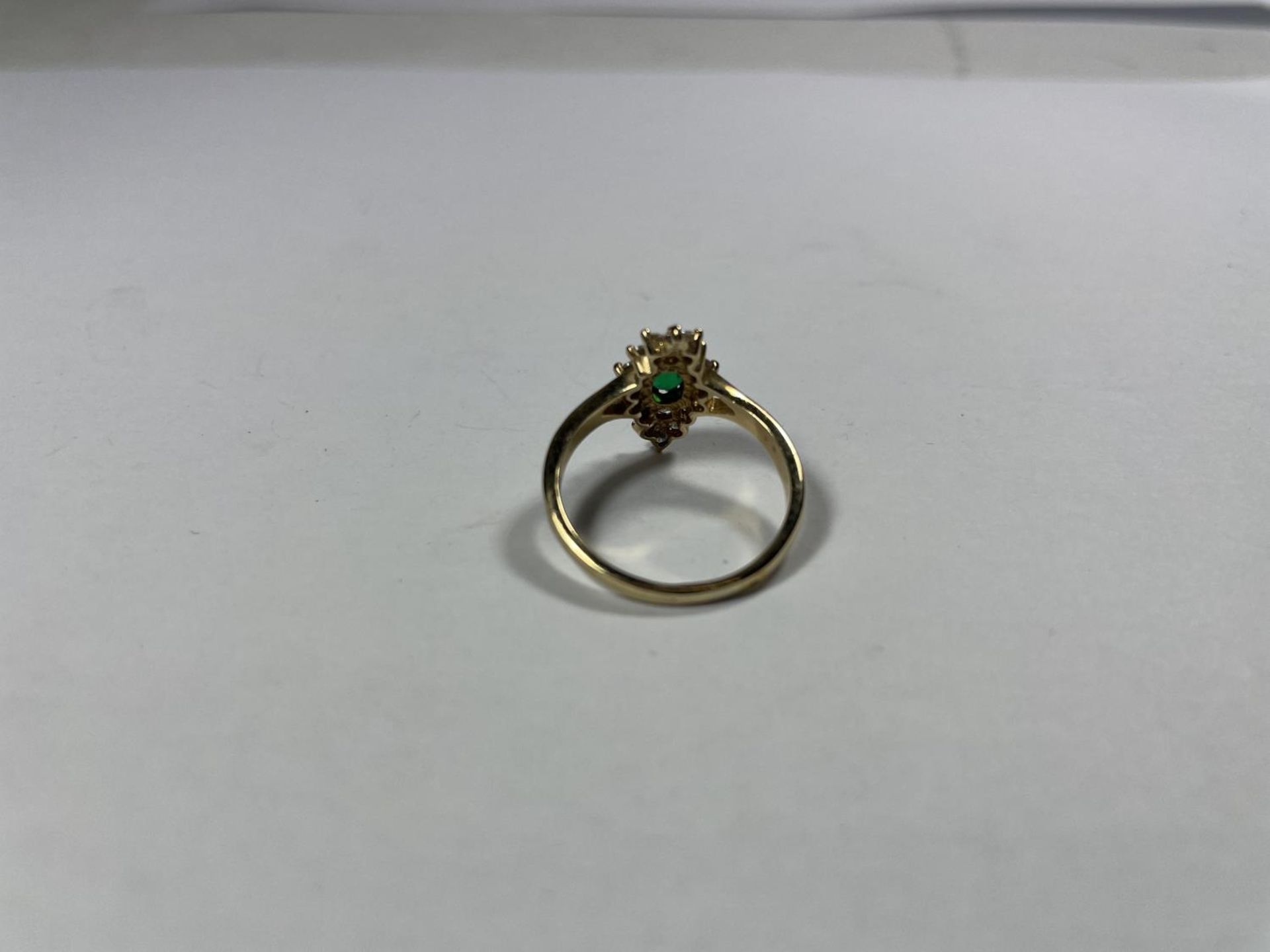 A 9 CARAT GOLD RING WITH CENTRE GREEN STONE SURROUNDED BY CUBIC ZIRCONIAS IN A DIAMOND SHAPE SIZE - Image 2 of 3