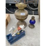 AN ASSORTMENT OF ITEMS TO INCLUDE TWO OIL LAMPS AND A CAST TRICK PONY MONEY BOX