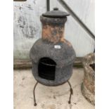 A GARDEN STOVE CHIMiNEA WITH TRIPOD STAND