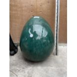 A DECORATIVE GREEN GLAZED TERRACOTTA GARDEN EGG ORNAMENT