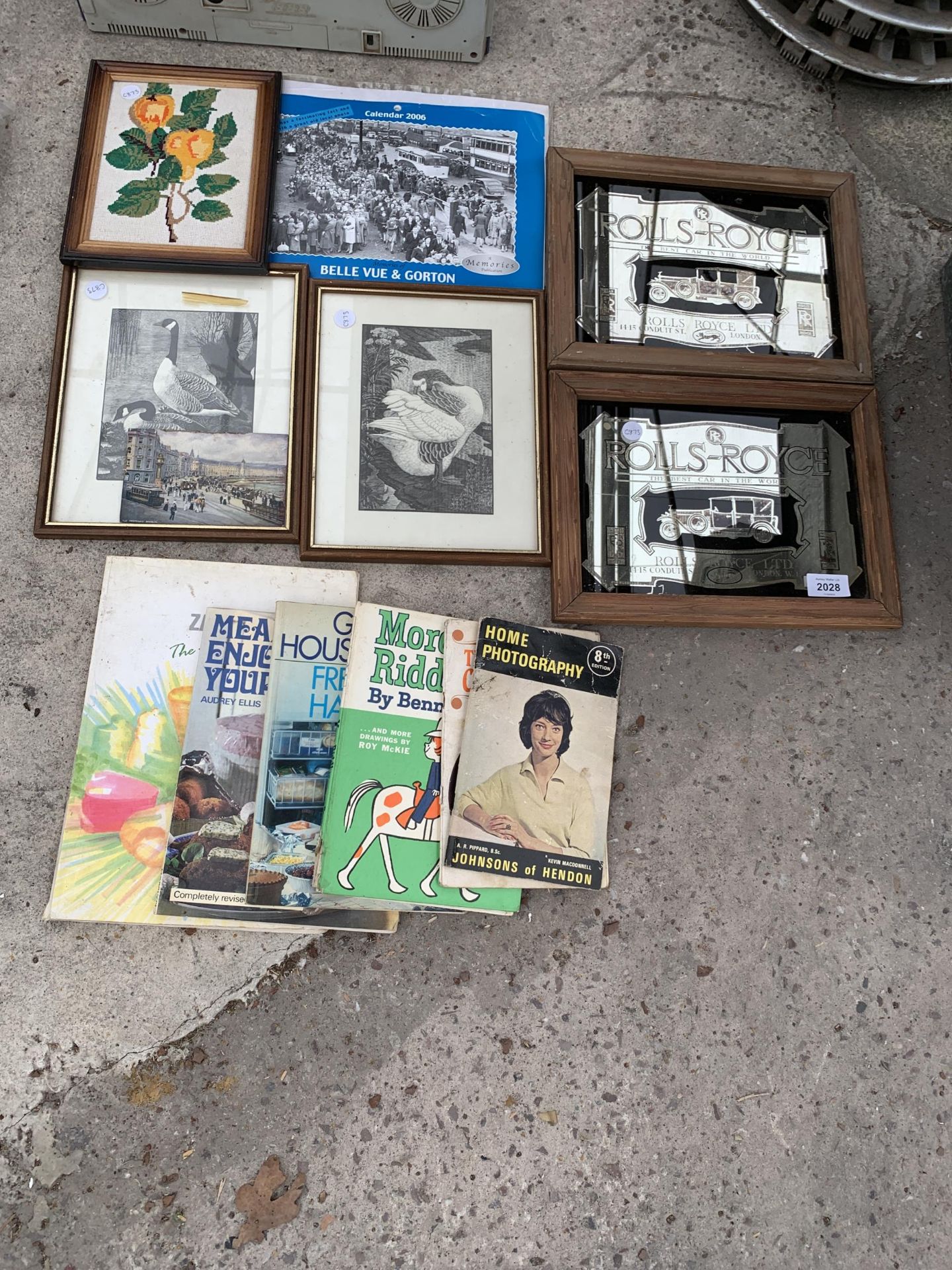 AN ASSORTMENT OF FRAMED PICTURES AND BOOKS TO INCLUDE TWO FRAMED ROLLS ROYCE ADVERTISING MIRRORS