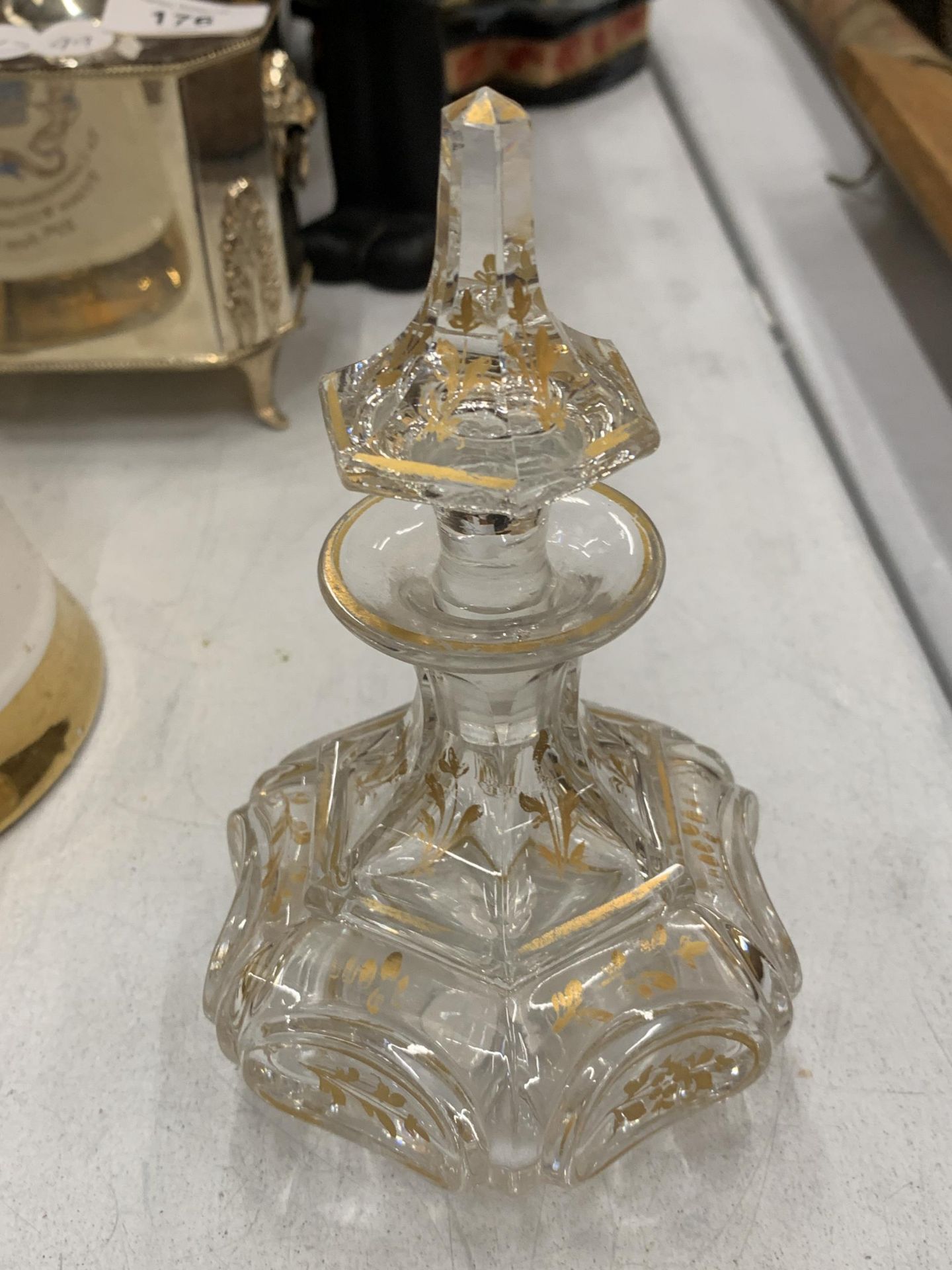 A GEORGIAN GLASS AND GILDED PERFUME BOTTLE