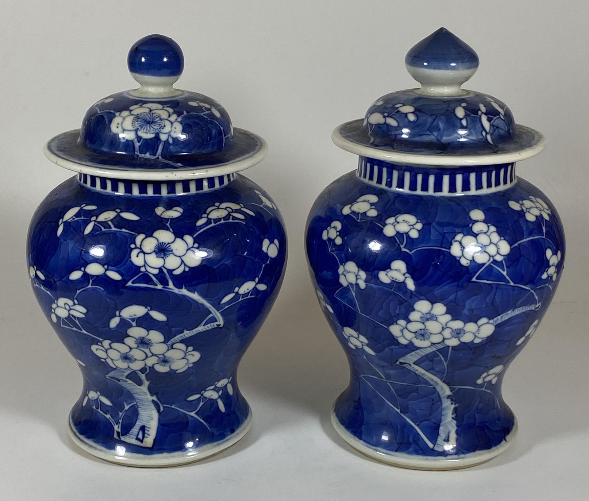 A PAIR OF 19TH/20TH CENTURY CHINESE BLUE AND WHITE PRUNUS BLOSSOM PATTERN PORCELAIN LIDDED TEMPLE