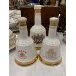 THREE GRADUATED BELL'S WHISKY DECANTERS