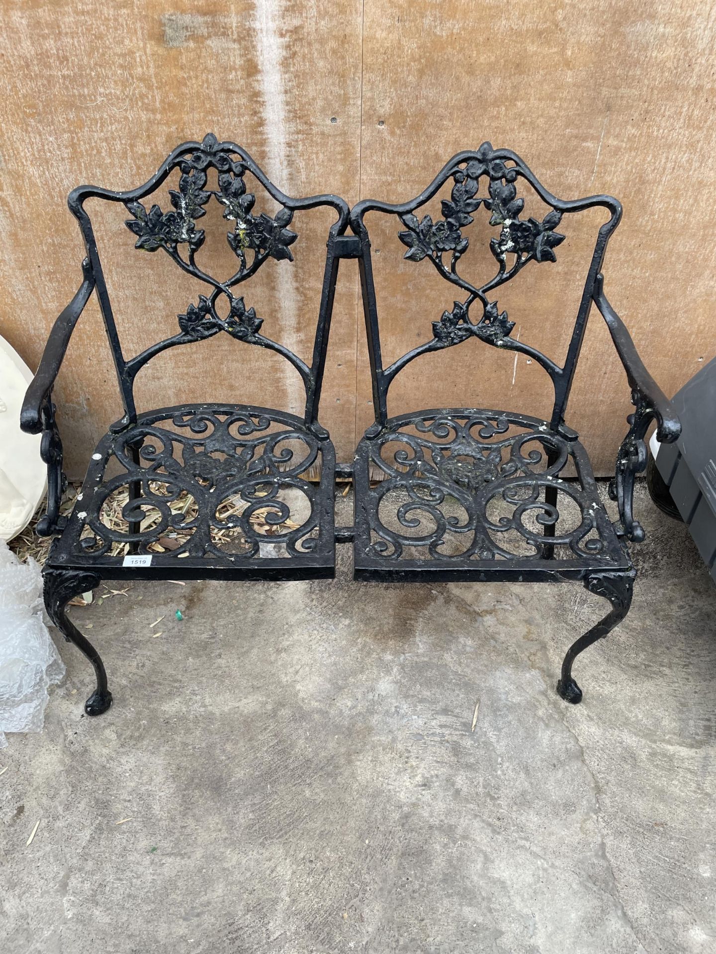 A CAST ALLOY TWO SEATER GARDEN BENCH