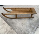 A VINTAGE WOODEN SLATTED SLEDGE