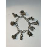 A SILVER CHARM BRACELET WITH NINE CHARMS