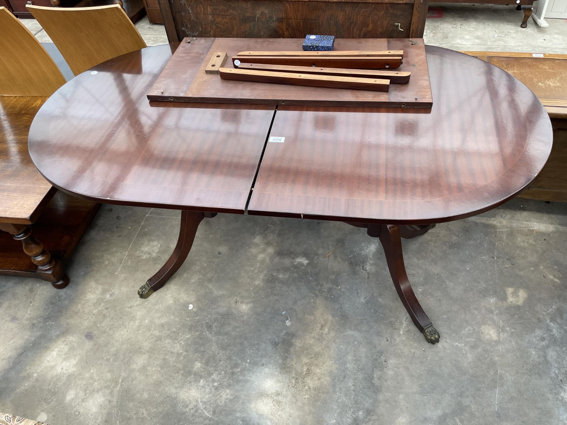 A REGENCY STYLE TWIN-PEDESTAL EXTENDING DINING TABLE, 55 X 32" (LEAF 14")