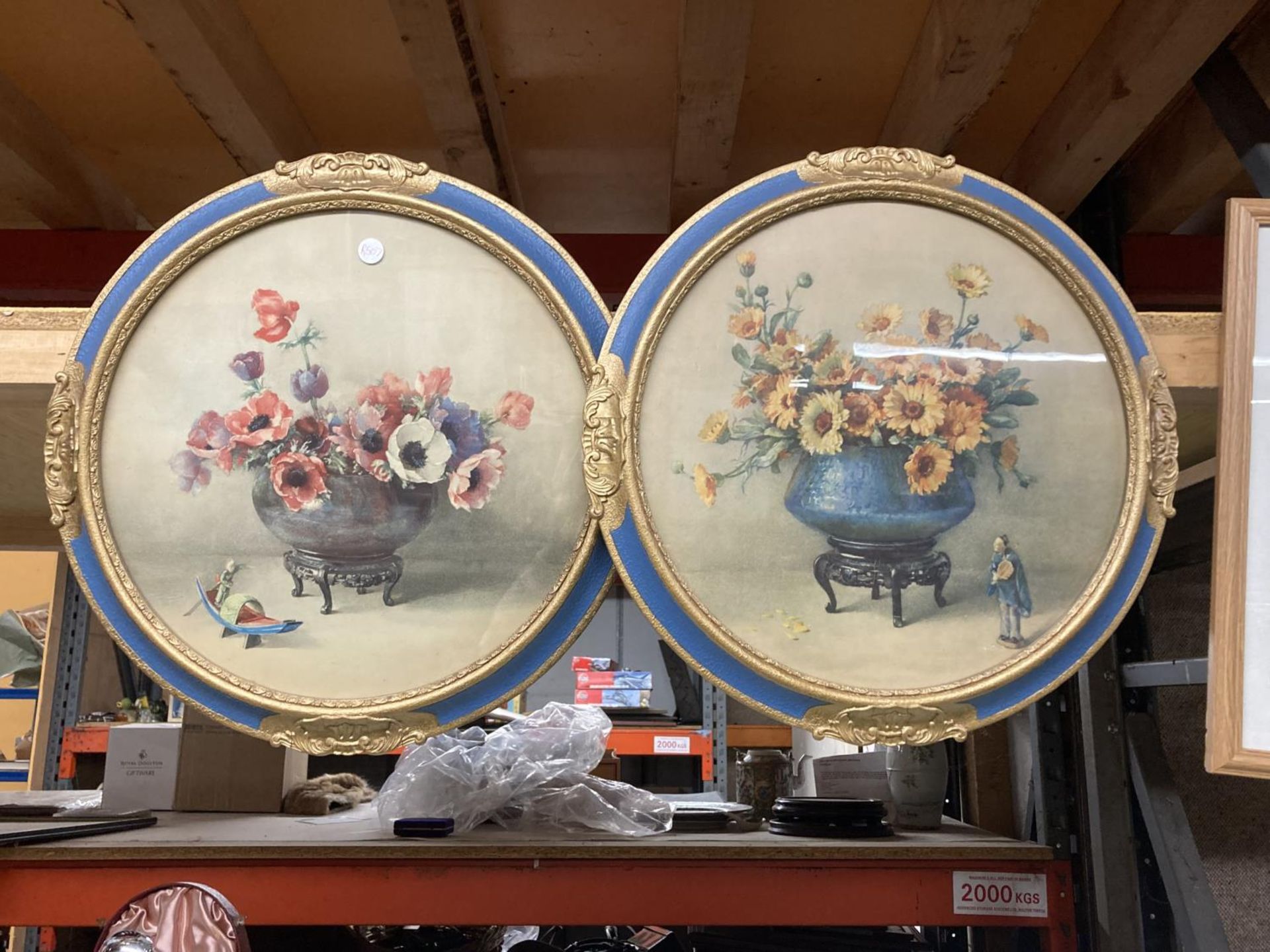 A PAIR OF CIRCULAR STILL LIFE PRINTS IN BLUE AND GILT FRAMES