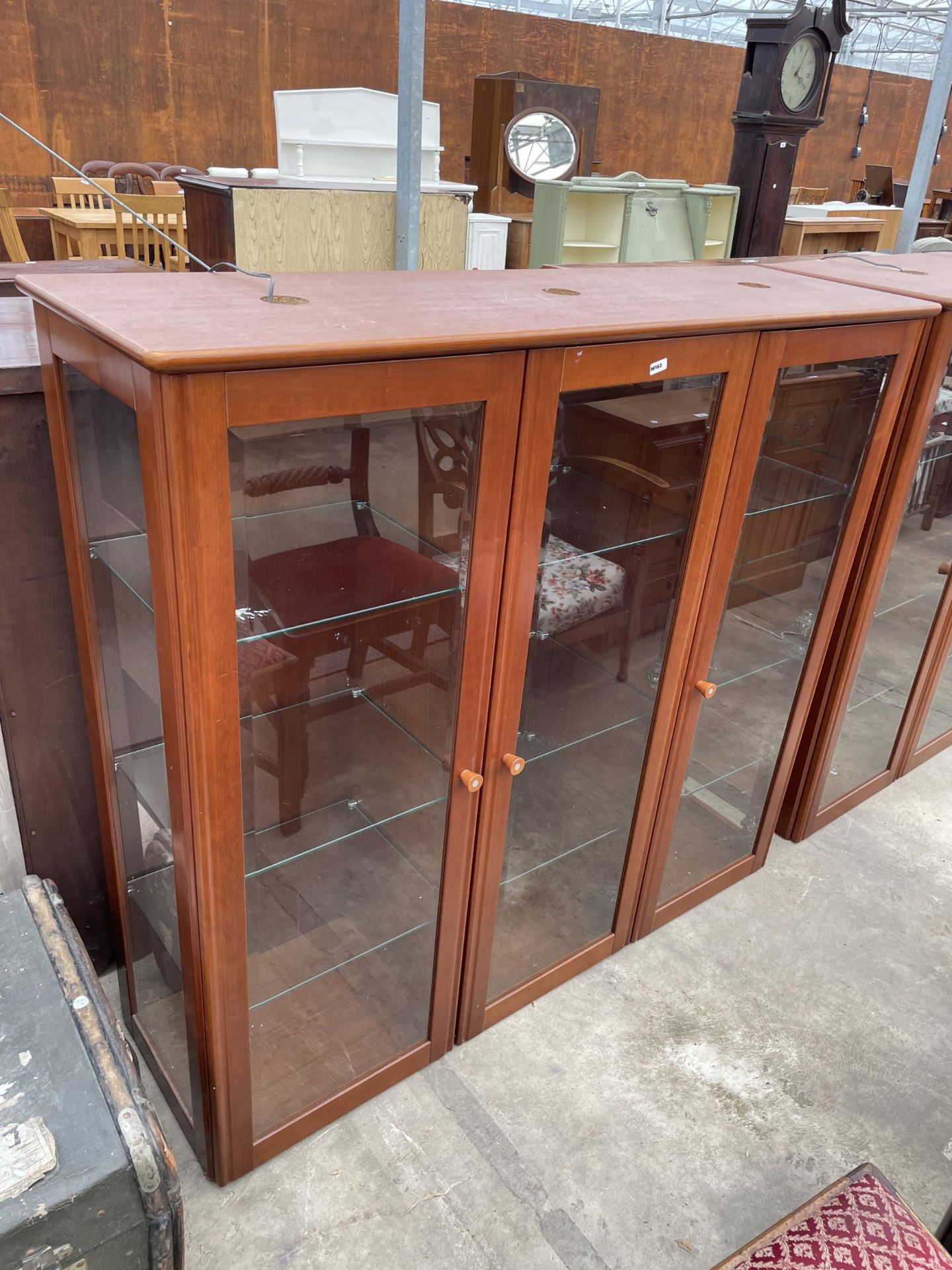 A PAIR OF MODERN THREE DOOR GLASS FRONTED DISPLAY CABINETS, 51.5" WIDE, 15.5" DEEP AND 47" HIGH - Image 2 of 3