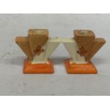 A PAIR OF ART DECO MYOTT & CO HAND PAINTED CANDLE HOLDERS