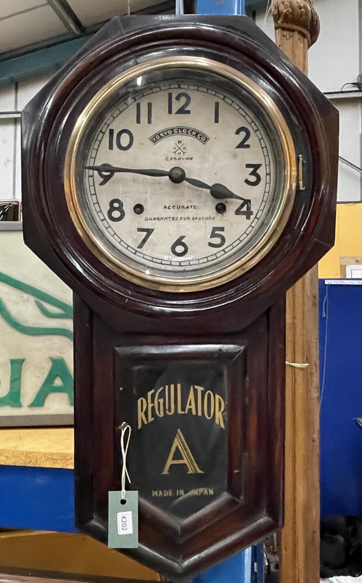 A WOODEN CASED TOKYO CLOCK CO REGULATOR WALL CLOCK WITH PENDULUM AND KEY