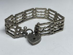 A MARKED SILVER FOUR BAR GATE BRACELET WITH HEART PADLOCK AND SAFETY CHAIN WEIGHT 15.2 GRAMS