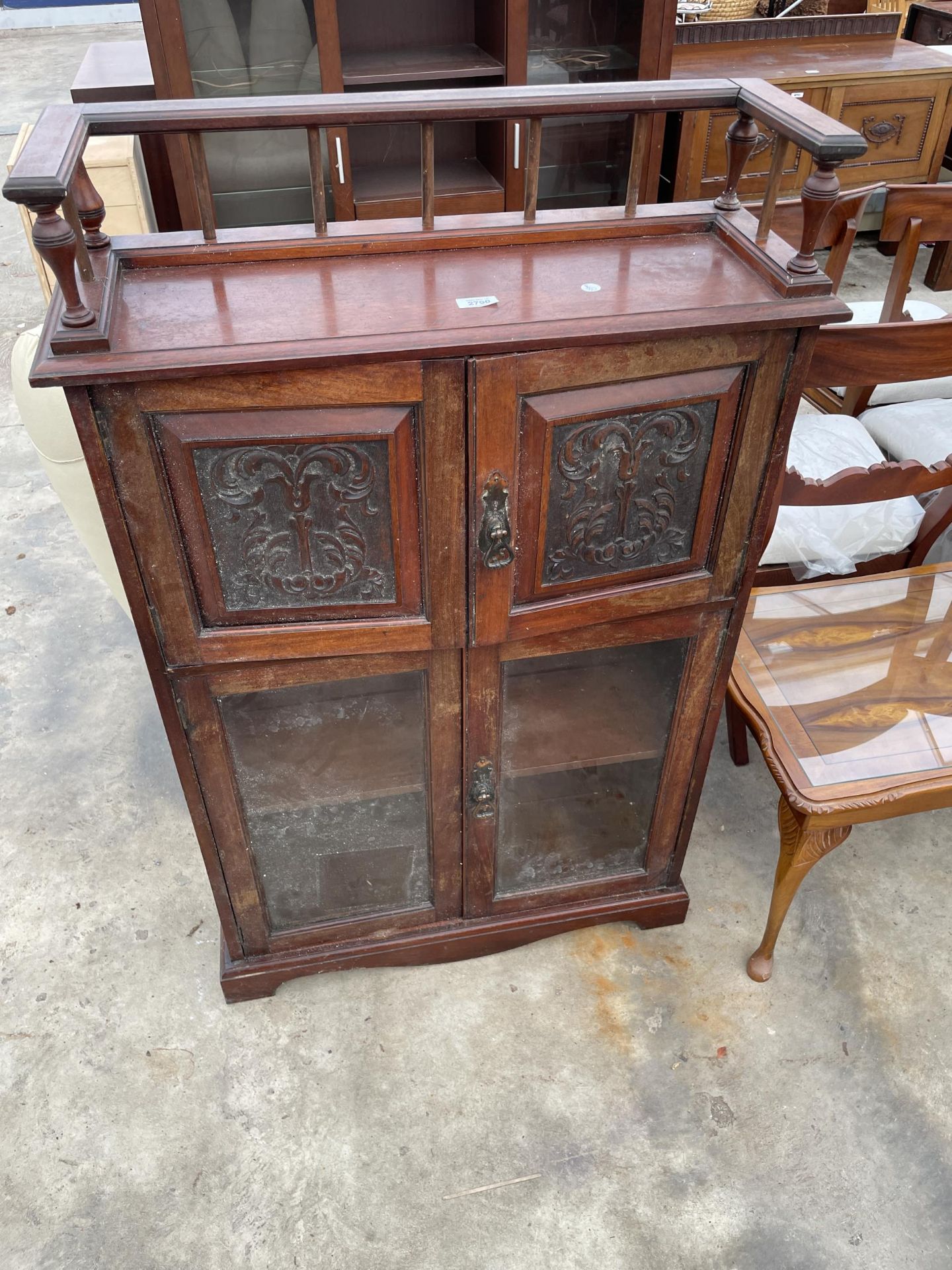 AN EDWARDIAN WALNUT MUSIC CABINET WITH GALLERY TOP AND FOUR DOORS, TWO BEING GLAZED AND TWO