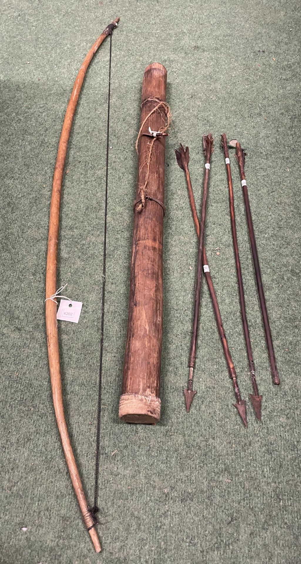 AN ANTIQUE MASSAI BOW, QUIVER AND FOUR ARROWS (ONE WITH HEAD DETACHED BUT PRESENT) C1840