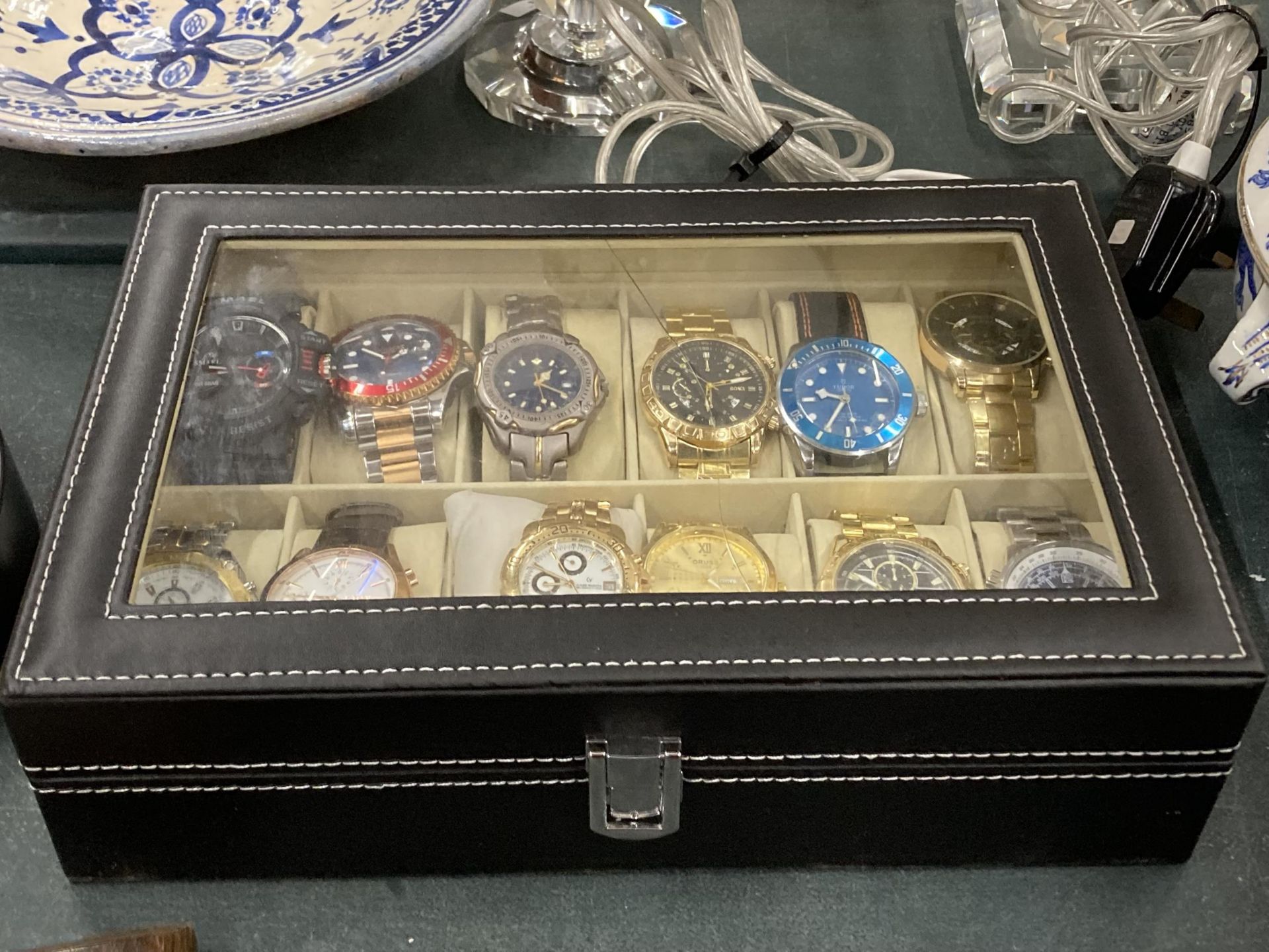 A LEATHER CASE OF TWELVE FASHION WATCHES